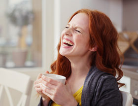 Woman laughing at a joke