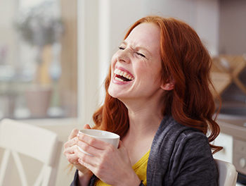 Woman laughing at a joke