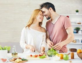 Couple cooking vegetables together