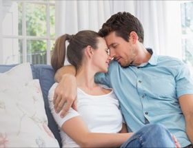 Couple cuddling on the couch and falling in love