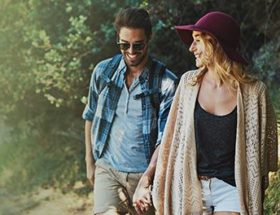 Male and female friend on a walk through the forest