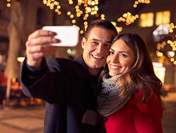 Happy couple taking a Christmas selfie