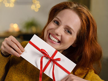 Beautiful red headed woman with a love letter