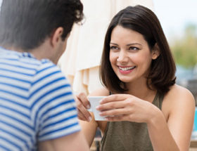Woman smiling at a man as a sign she likes him