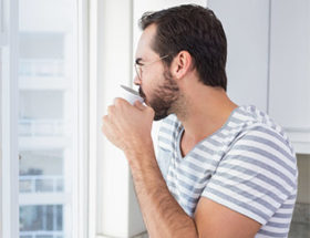 Man looking out the window and missing someone