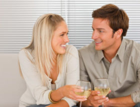 couple sitting really close on the sofa