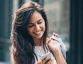 Beautiful woman using a dating app on her phone