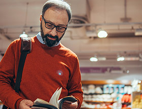 man reading in bookstore