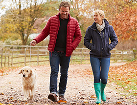 Couple walking the dog together