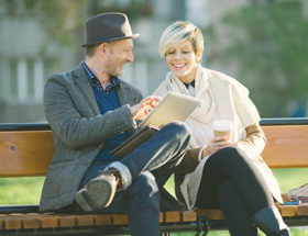 Atheist couple sitting on a park bench sharing ideas