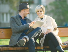 Atheist couple sitting on a park bench sharing ideas