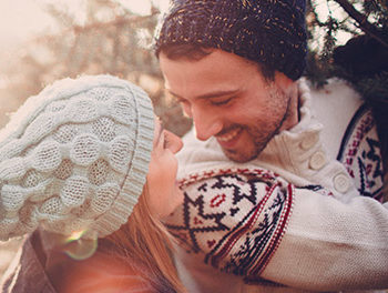 Smiling couple in winter woollens getting their Christmas tree