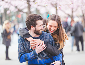 Couple wandering through cherry blossom in Vancouver