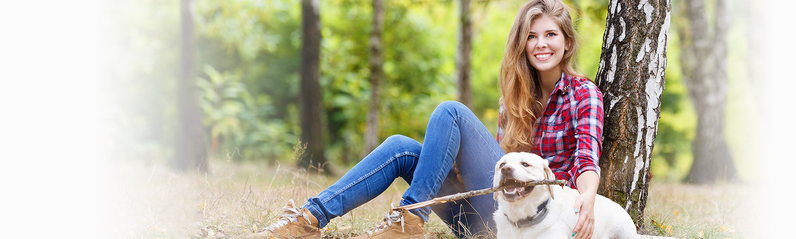 Happy woman sitting with puppy