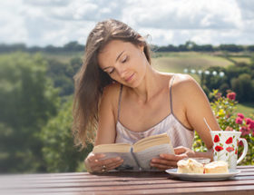 Pretty woman reading a book outside