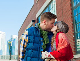 Toronto couple kissing in a downtown area