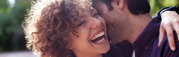 woman and man laughing outside 