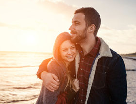 Couple hugging on a beach during sunset