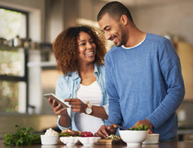 Vegan couple cooking vegetables together