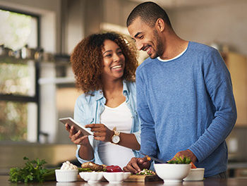 Vegan couple cooking vegetables together