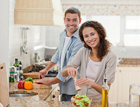 Couple cooking vegetables together