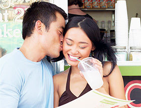 Filipino couple hugging and drinking bubble tea