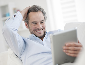 Handsome older man on his tablet