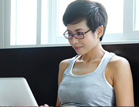 Pretty Filipina woman on her laptop