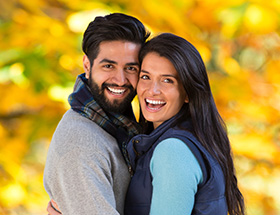 Muslim dating couple embracing in fall