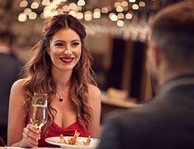 Beautiful woman drinking wine in an elegant, rich restaurant