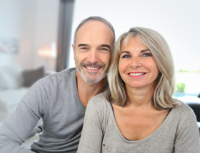 Couple sitting together grinning