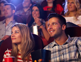 Couple at the movies eating popcorn