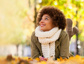 woman lying on autumn leaves