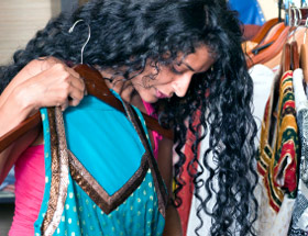 Woman trying on a blue sari 