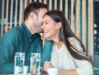 Man making a woman laugh over water