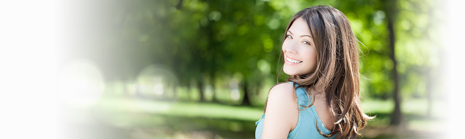 Beautiful woman smiling at you in a park
